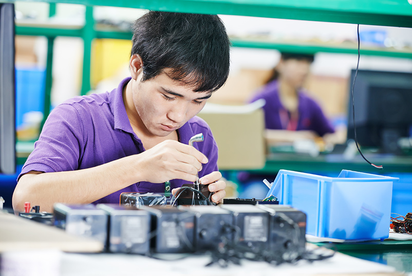 Worker assembling components in a factory. (iStock Photo)